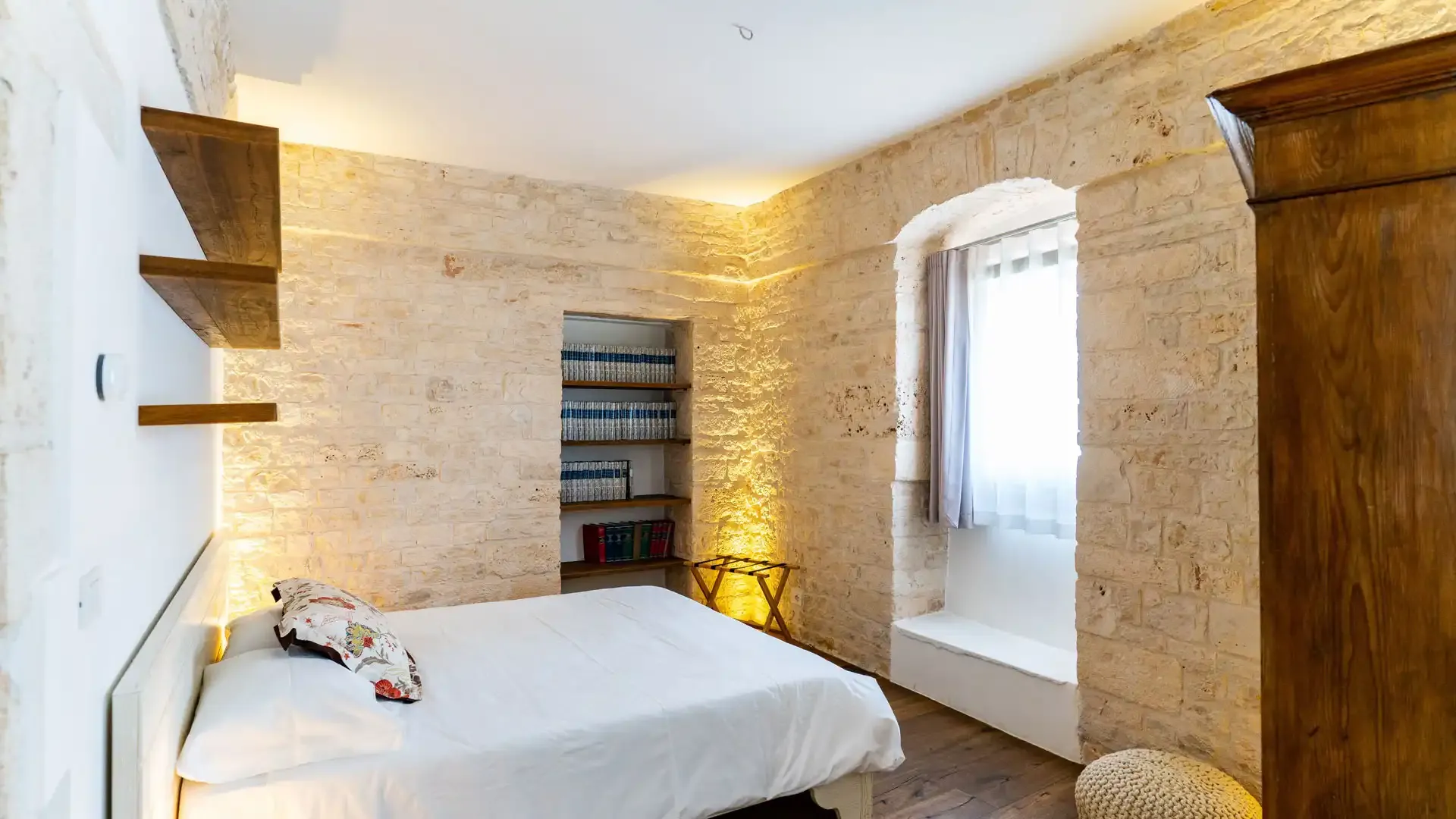 Cozy room with stone walls and warm lighting.