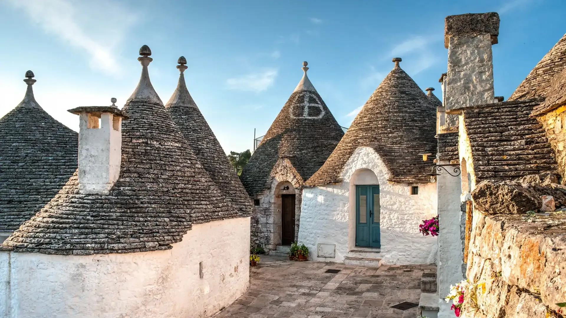 Trulli of Alberobello with conical roofs and white walls.