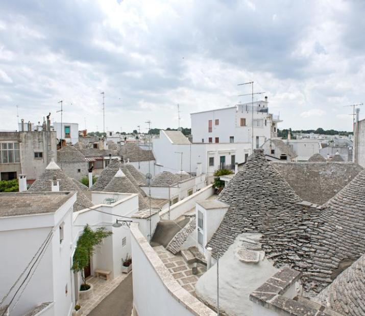 View of the conical roofs of trulli in an Italian village.