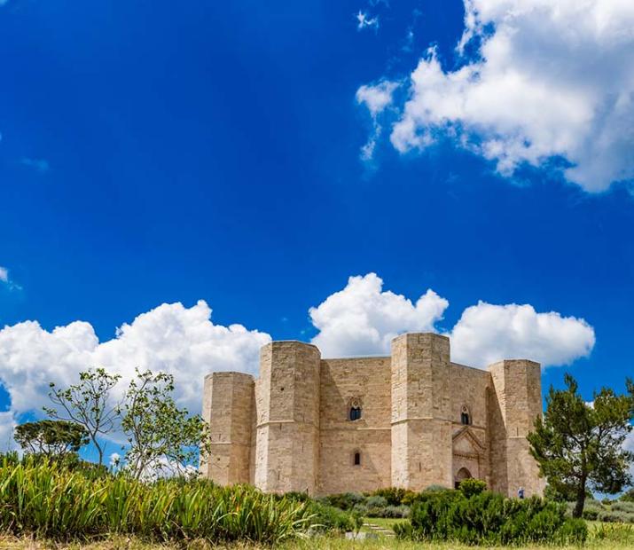 Castel del Monte, une architecture médiévale unique sous un ciel bleu.